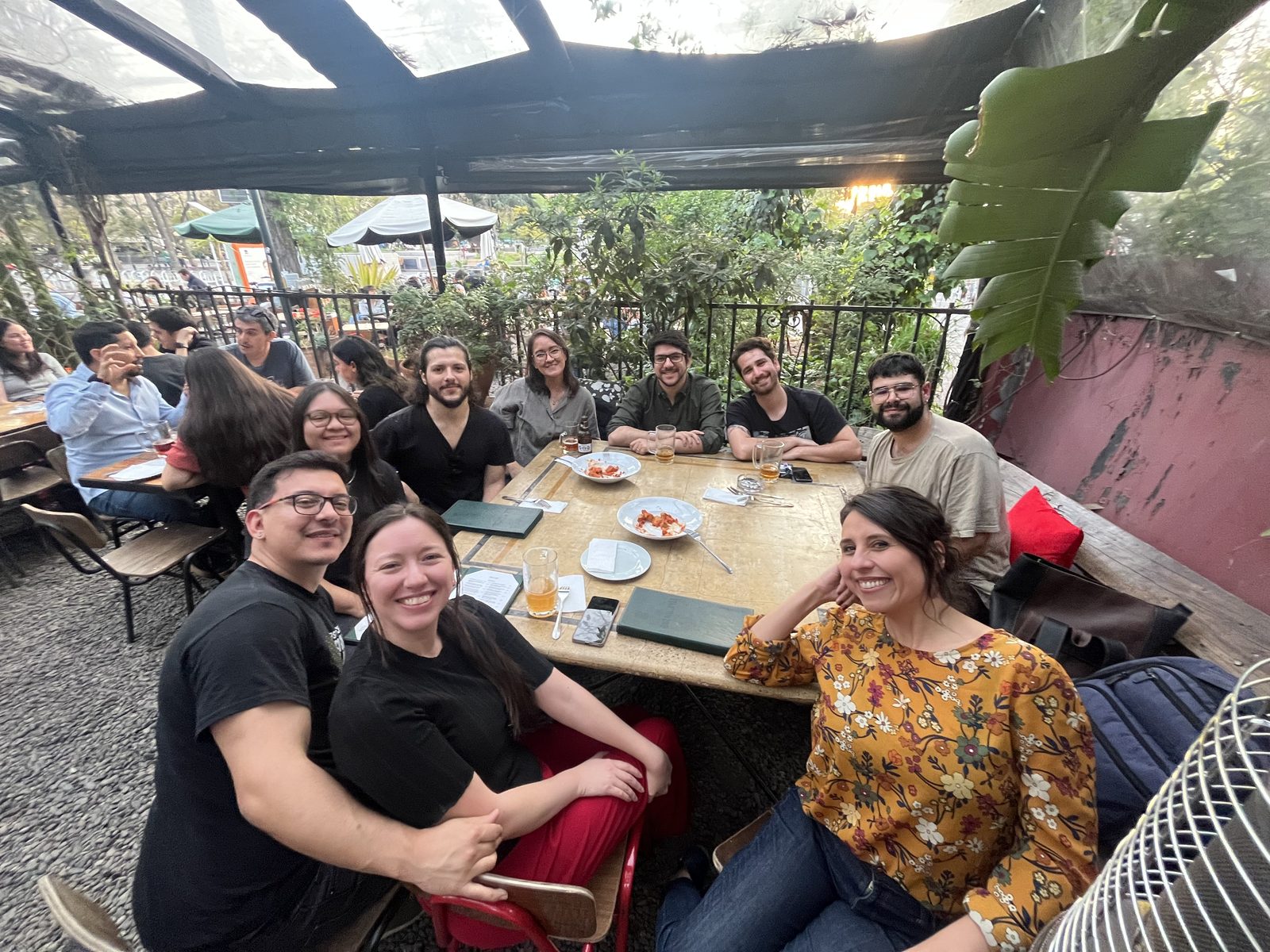 Group members sharing a meal at an outdoor restaurant table